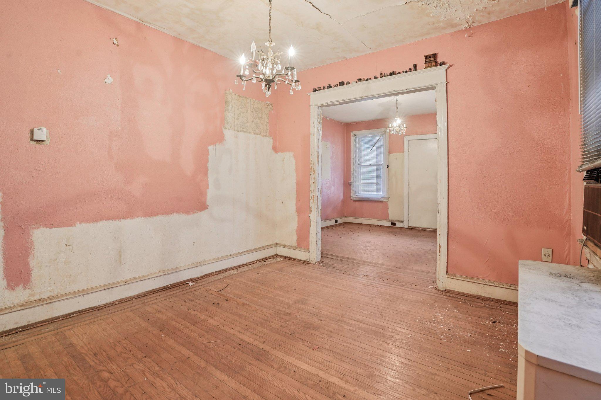 5322 James Street Philadelphia, PA 19137 - Photo 10 of 40 a view of a hallway with wooden floor and chandelier