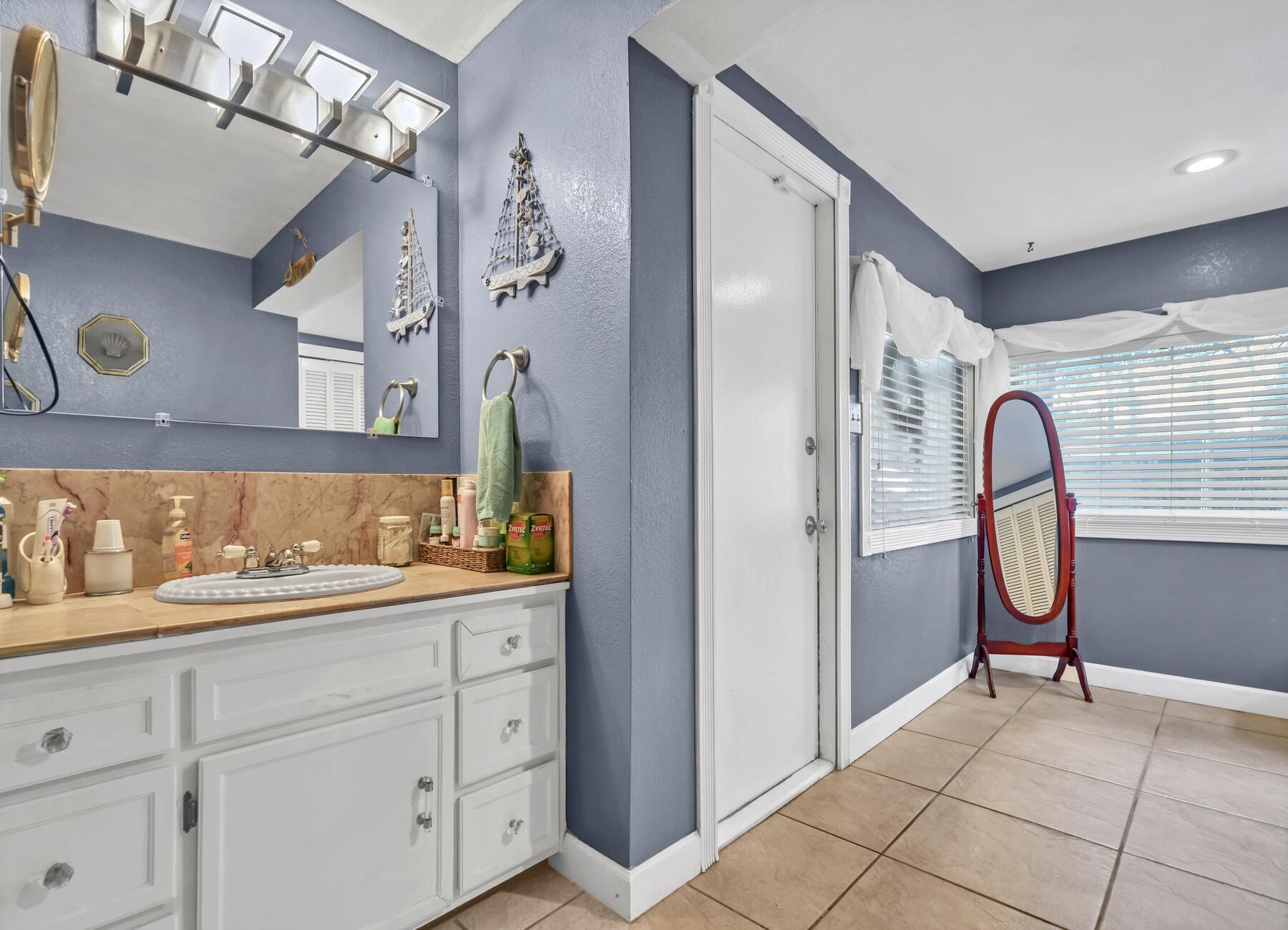 43 Ferry Road Northeast Fort Walton Beach, FL 32548 - Photo 14 of 23 a spacious bathroom with a mirror sink and shower