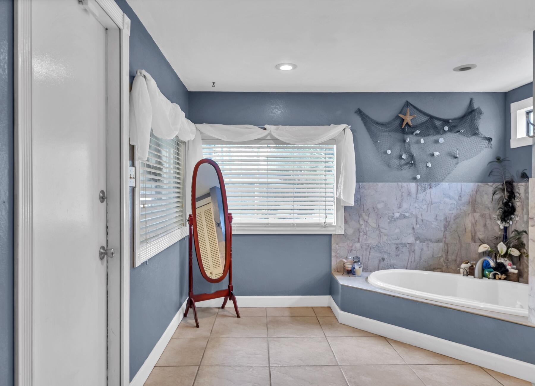 43 Ferry Road Northeast Fort Walton Beach, FL 32548 - Photo 15 of 23 a bathroom with a tub and a window