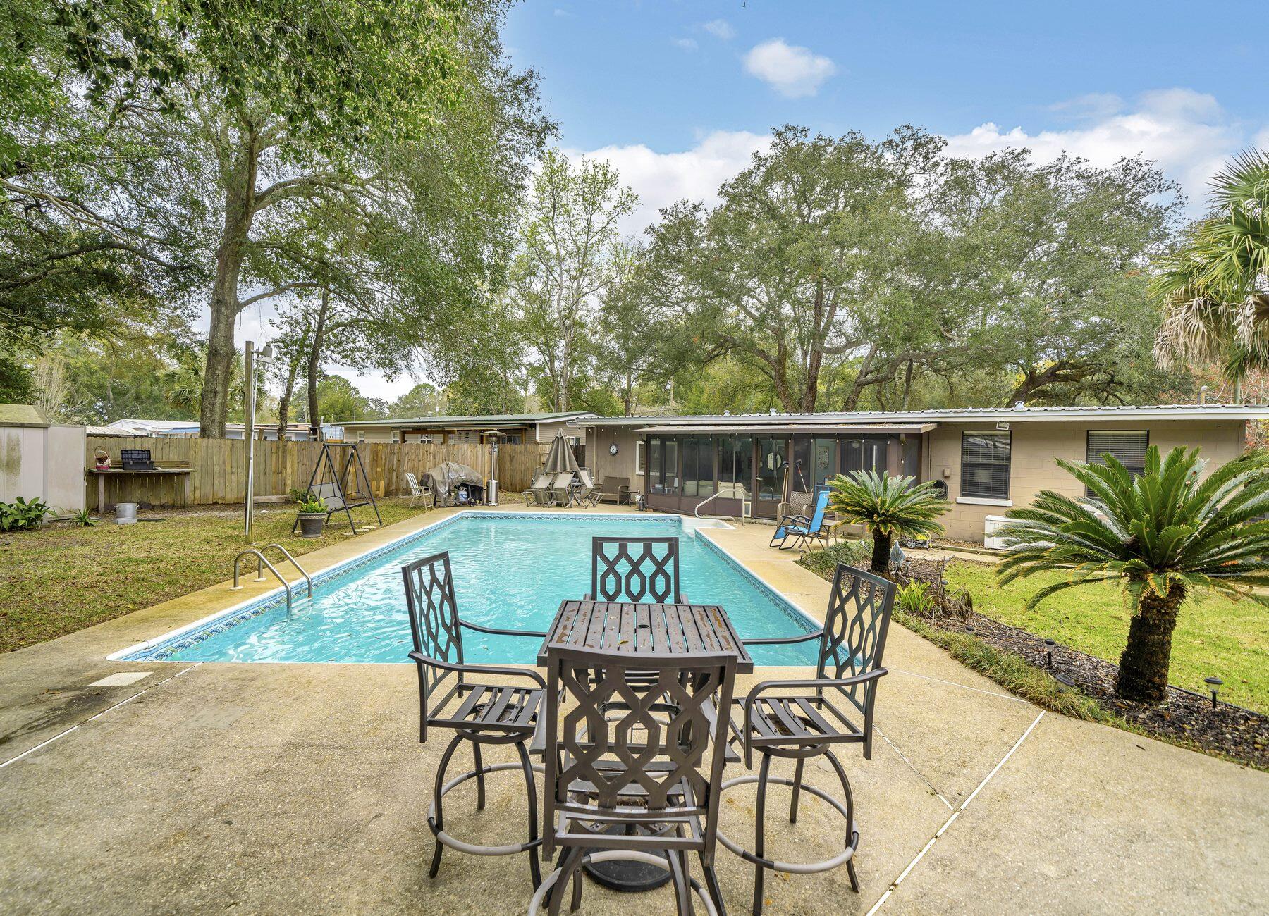43 Ferry Road Northeast Fort Walton Beach, FL 32548 - Photo 20 of 23 a view of a swimming pool with a patio and a garden