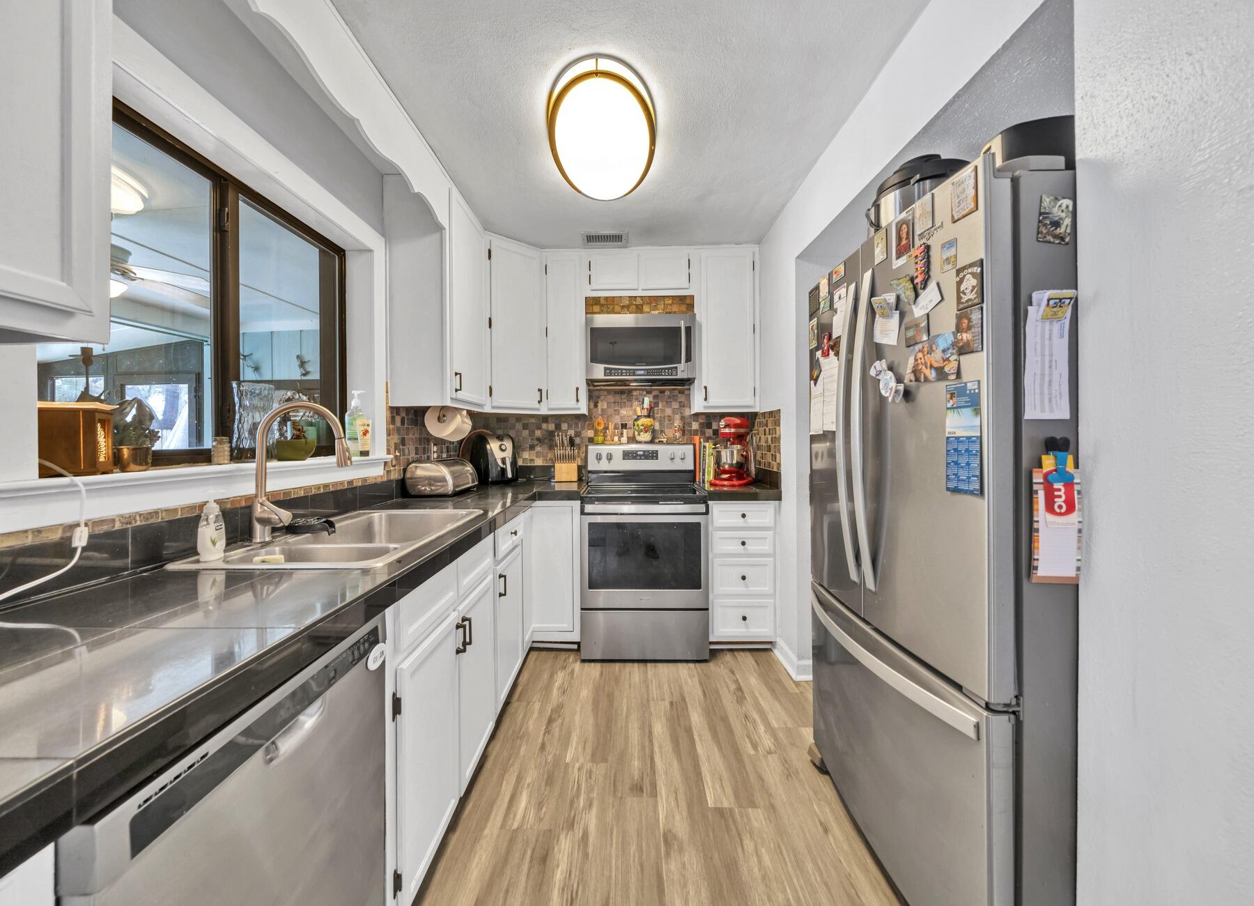 43 Ferry Road Northeast Fort Walton Beach, FL 32548 - Photo 5 of 23 a kitchen with stainless steel appliances granite countertop a refrigerator a stove and a sink
