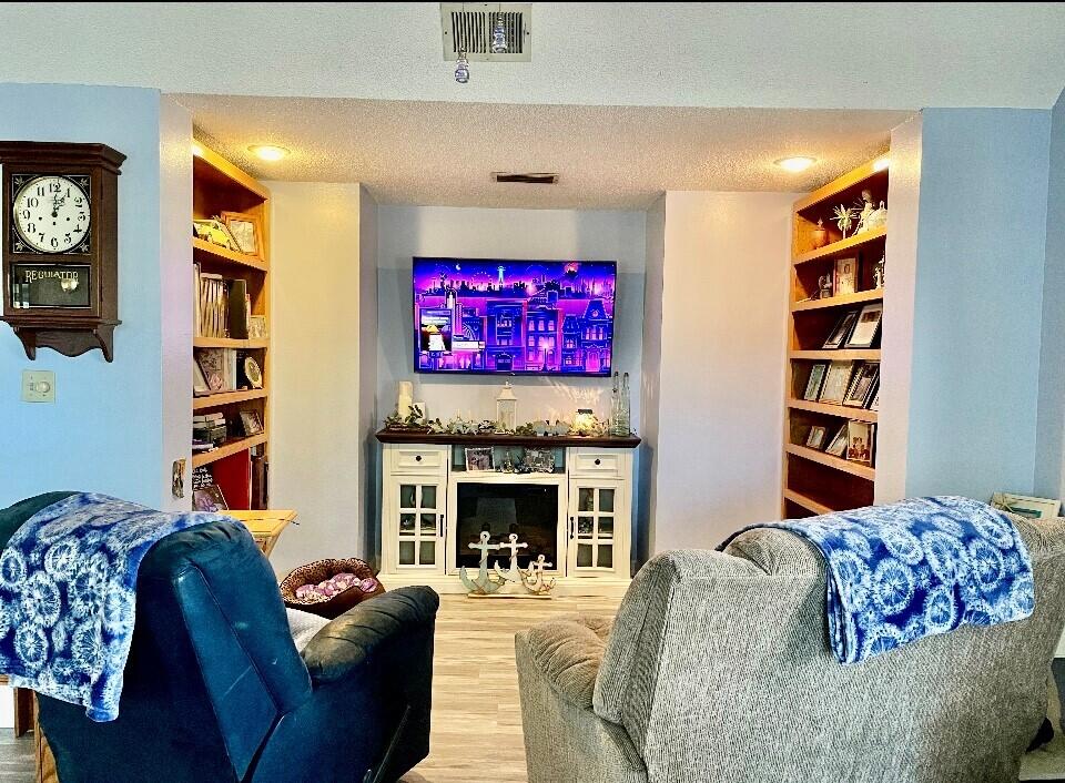 43 Ferry Road Northeast Fort Walton Beach, FL 32548 - Photo 8 of 23 a living room with furniture a flat screen tv and a fireplace