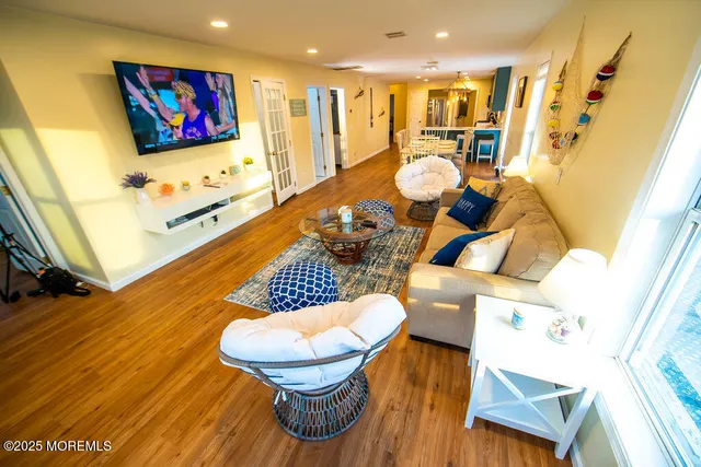 a living room with dining room and wooden floor