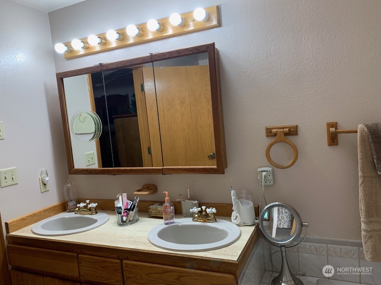 240 East Channel Drive Allyn, WA 98524 - Photo 12 of 33 a bathroom with a sink and a mirror