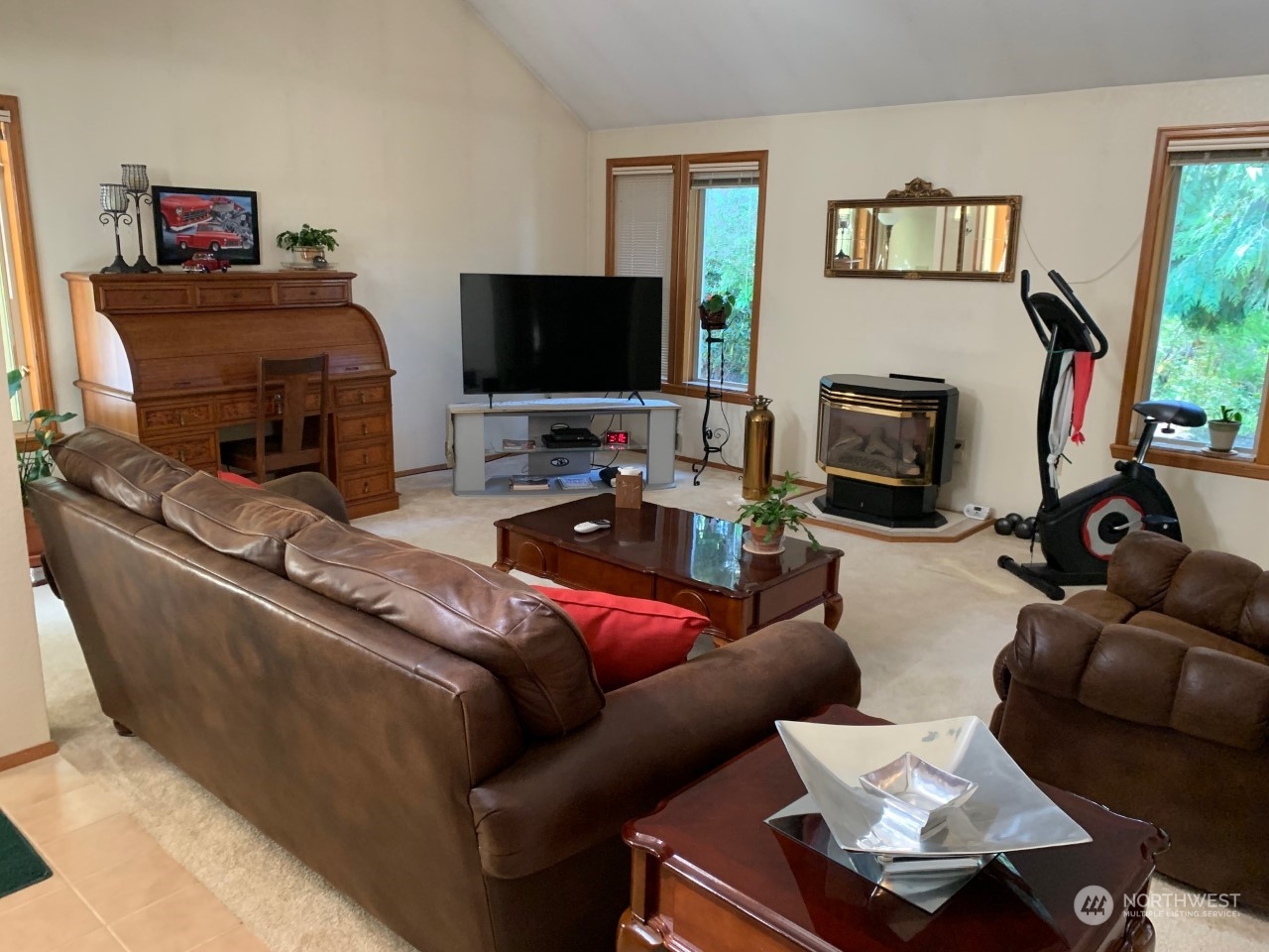 240 East Channel Drive Allyn, WA 98524 - Photo 16 of 33 a living room with furniture a flat screen tv and a fireplace