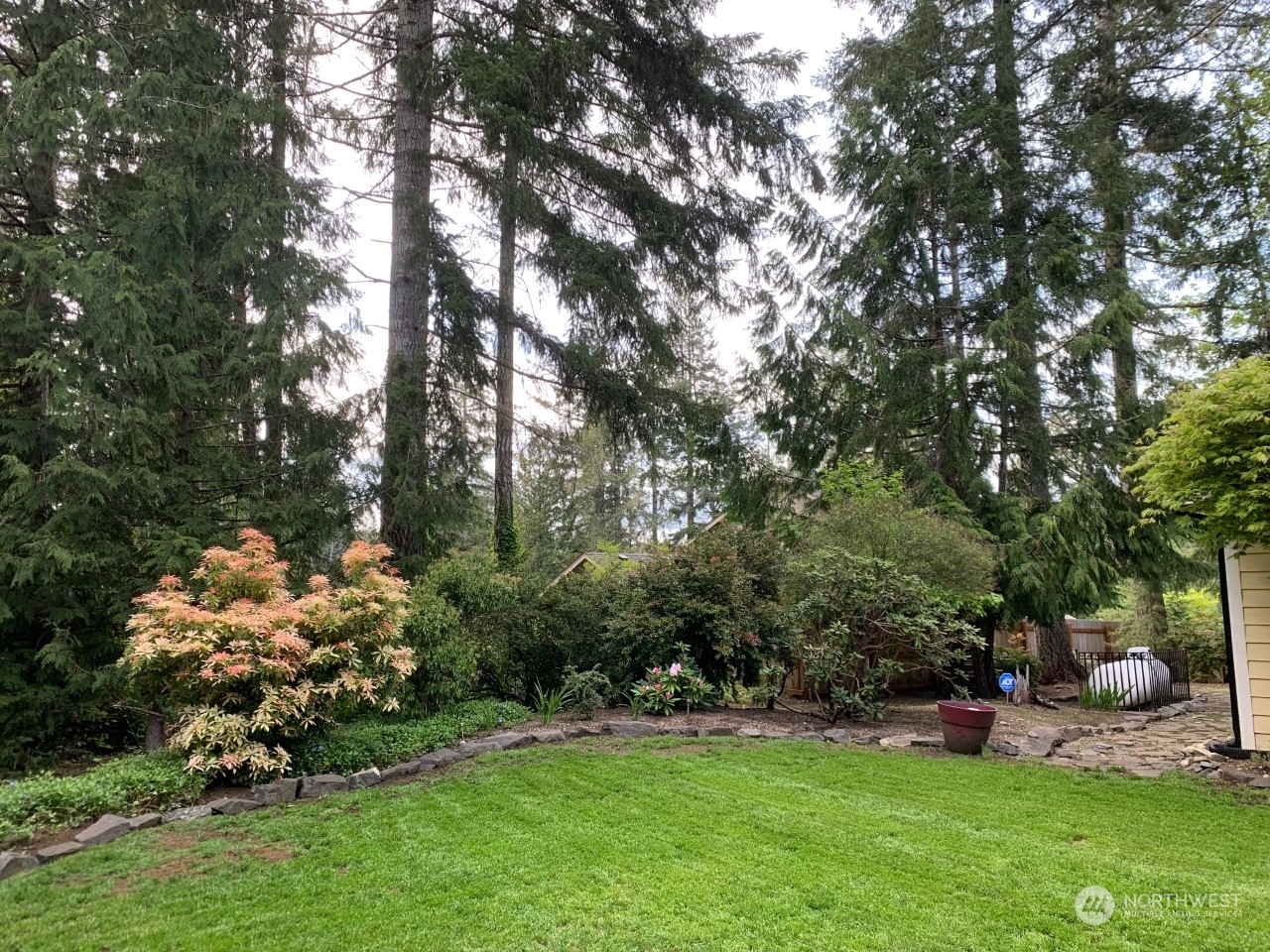 240 East Channel Drive Allyn, WA 98524 - Photo 20 of 33 a view of a garden with lawn chairs and plants