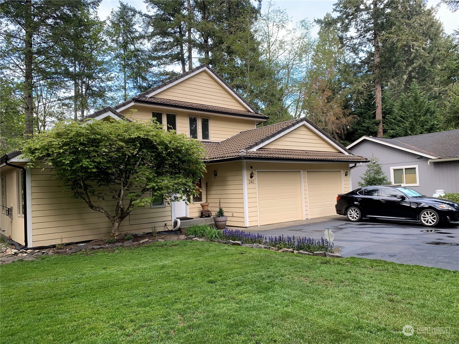 240 East Channel Drive Allyn, WA 98524 - Photo 2 of 33 a front view of a house with a garden and yard
