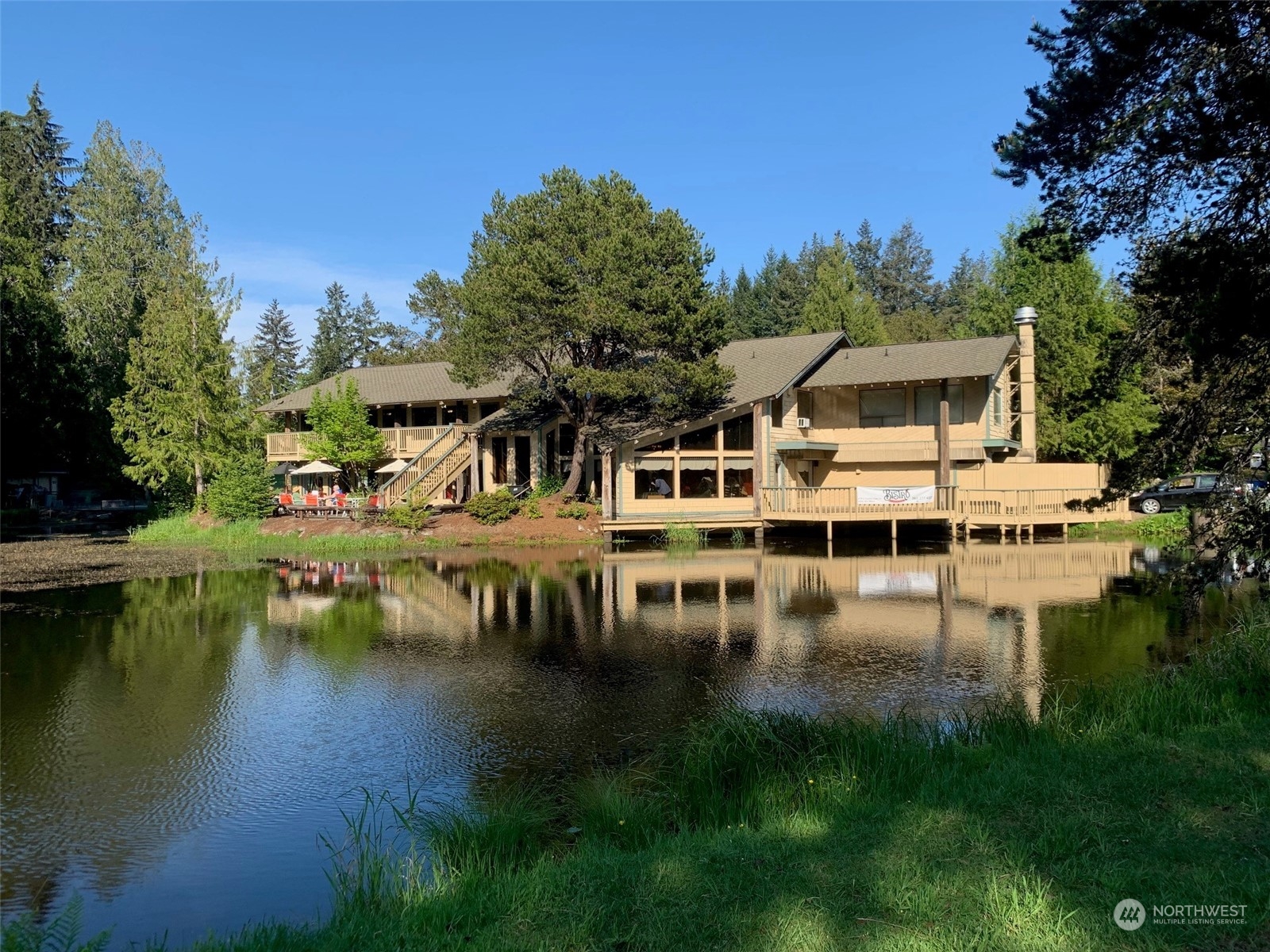 240 East Channel Drive Allyn, WA 98524 - Photo 30 of 33 a view of house with swimming pool and outdoor seating