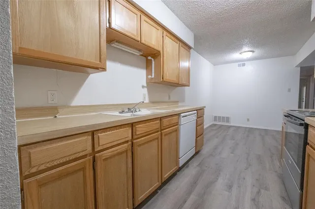 a kitchen with a sink and cabinets