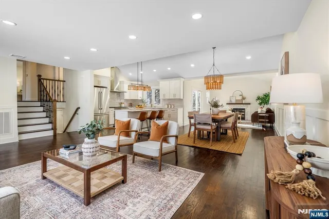 a dining room with furniture a chandelier and wooden floor