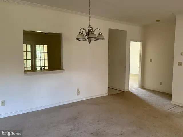 a view of a chandelier fan and a refrigerator in a room