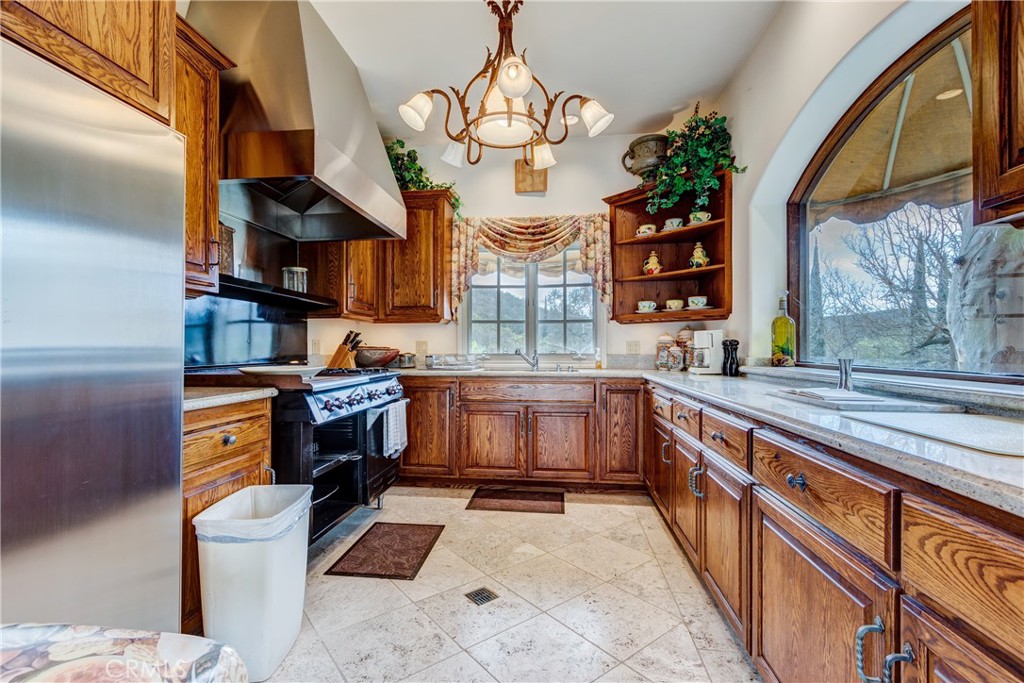 39250 Ortega Highway Fallbrook, CA 92028 - Photo 31 of 59 a kitchen with stainless steel appliances granite countertop a stove a sink and a refrigerator