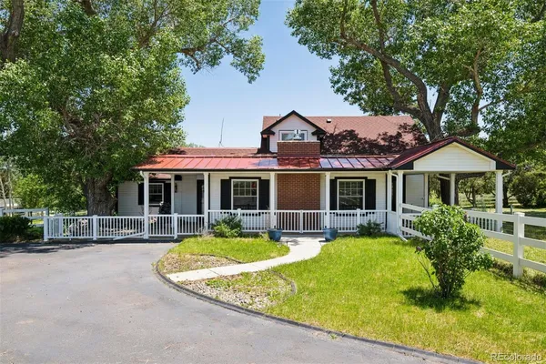 a front view of house with yard swimming pool and outdoor seating