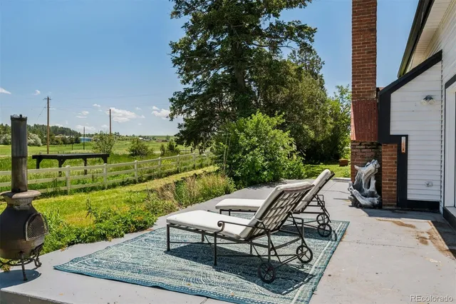 a view of a backyard with sitting area