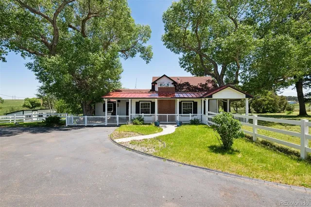 a front view of a house with a yard table and chairs