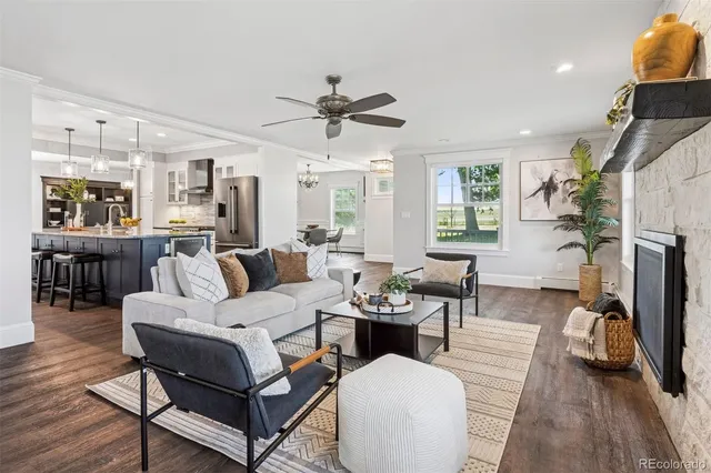 a living room with furniture a fireplace and a flat screen tv