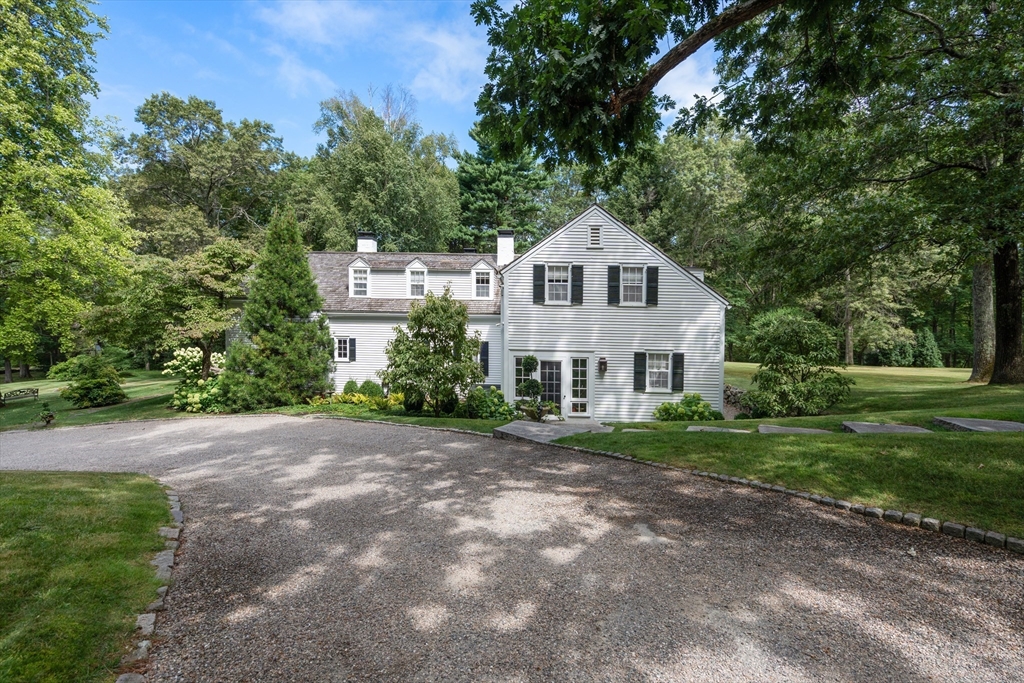 157 Centre Street Dover, MA 02030 - Photo 2 of 42 a front view of a house with a yard and trees