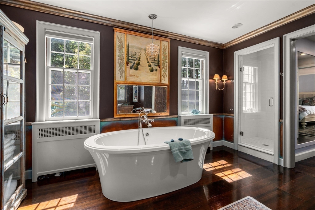 157 Centre Street Dover, MA 02030 - Photo 24 of 42 a white bath tub sitting in a bathroom next to a window