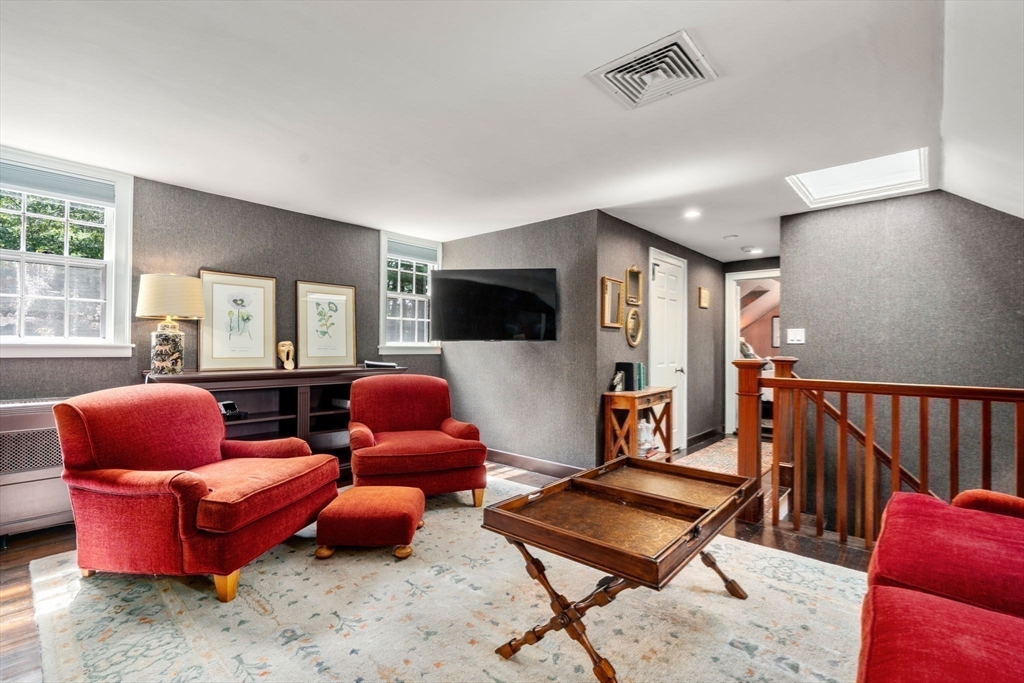 157 Centre Street Dover, MA 02030 - Photo 26 of 42 a living room with furniture a flat screen tv and a window