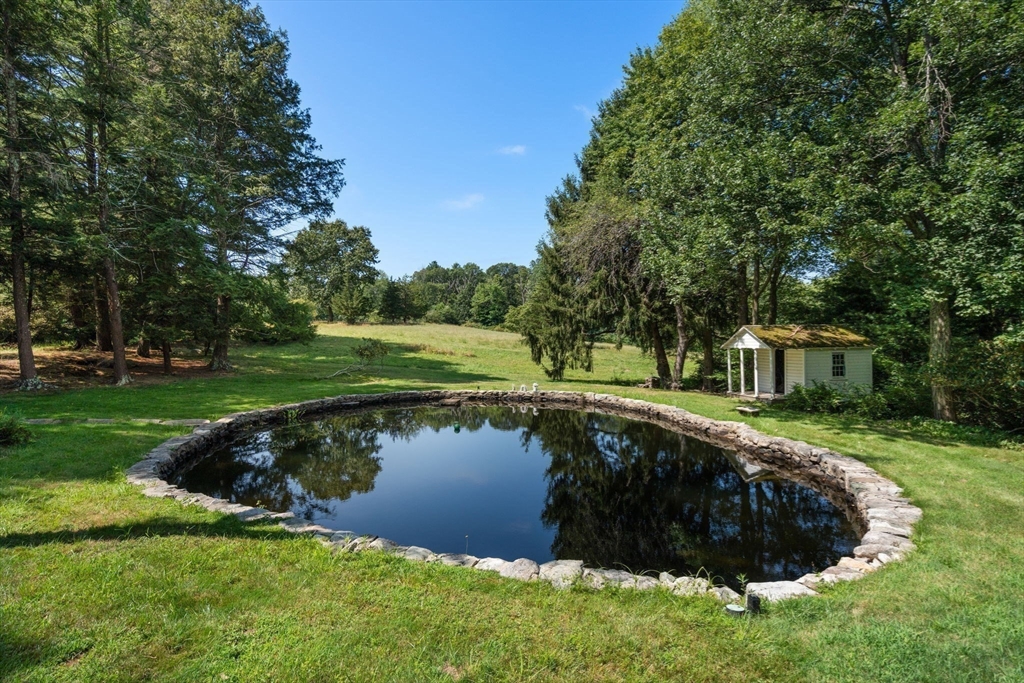 157 Centre Street Dover, MA 02030 - Photo 3 of 42 a swimming pool with outdoor seating and garden