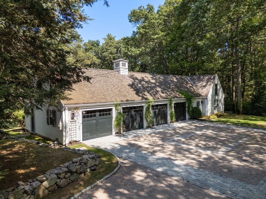 157 Centre Street Dover, MA 02030 - Photo 33 of 42 a front view of a house with a garden