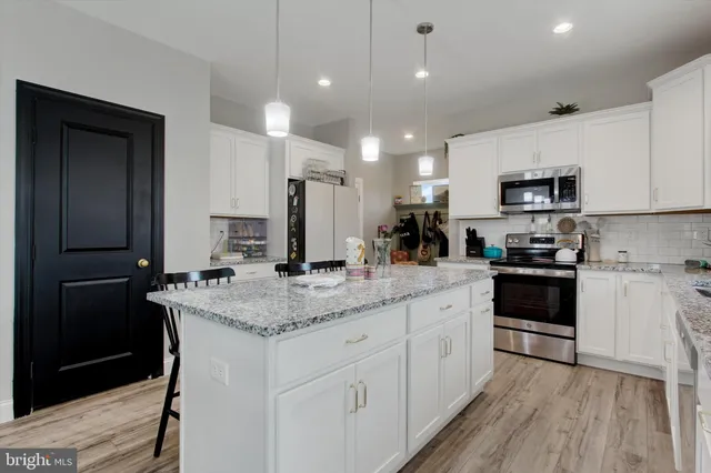 a kitchen with a sink stove and refrigerator