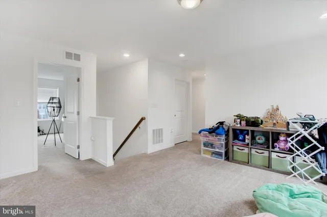 a view of a livingroom with furniture and white walls