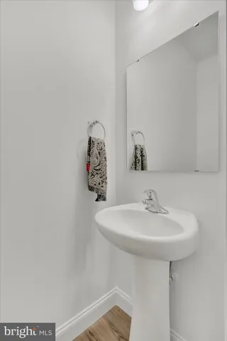 a bathroom with a sink a mirror and a toilet