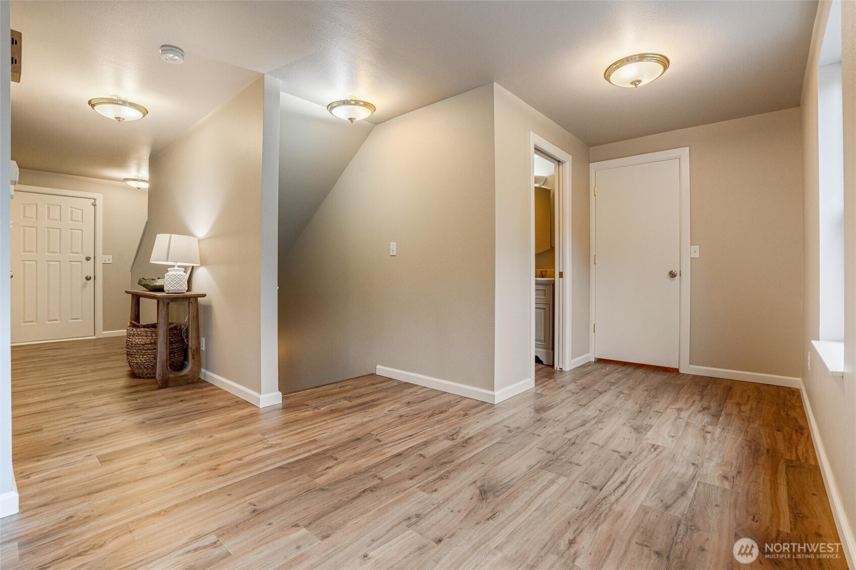 5735 Southeast Alpine Road Olalla, WA 98359 - Photo 12 of 40 an empty room with wooden floor and a bathroom