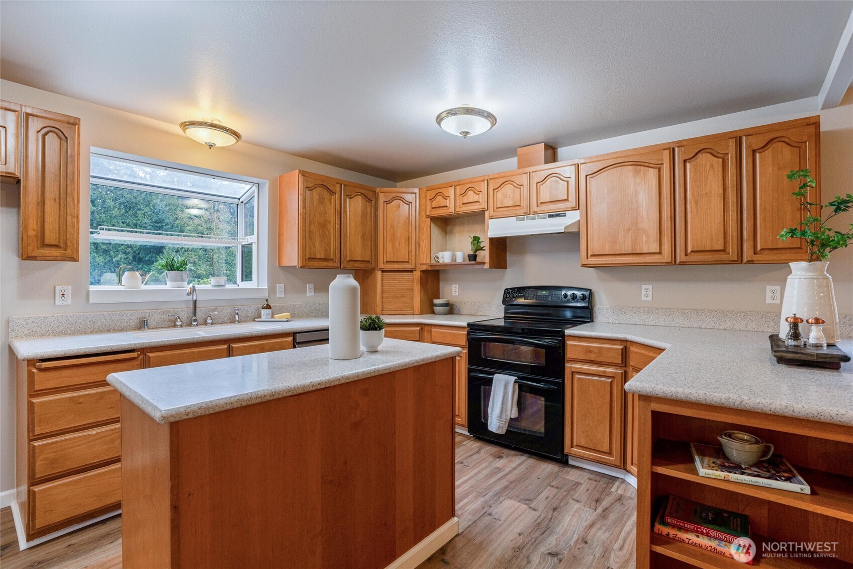 5735 Southeast Alpine Road Olalla, WA 98359 - Photo 10 of 40 a kitchen with stainless steel appliances granite countertop a stove a sink dishwasher and a refrigerator