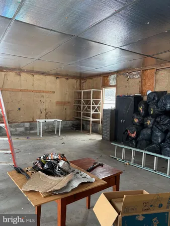 a view of a patio with table and chairs under an umbrella with a tree