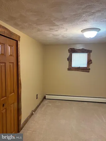 a bathroom with a toilet and a shower curtain