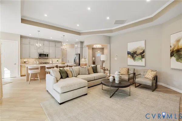 a living room with furniture and kitchen view