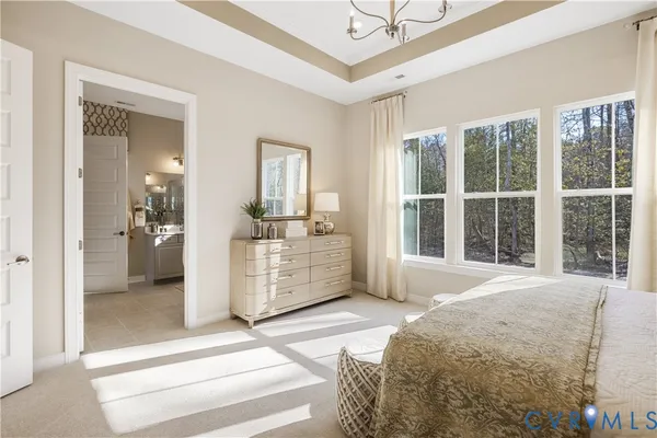 a bedroom with a balcony a bed and a large mirror
