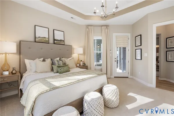 a bedroom with a bed couches and window