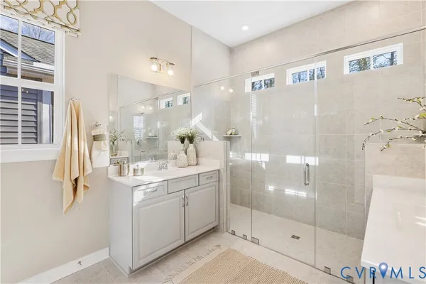 a bathroom with a shower sink and mirror