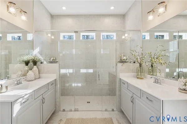 a bathroom with a shower sink and mirror