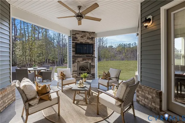 a living room with patio furniture and a floor to ceiling window