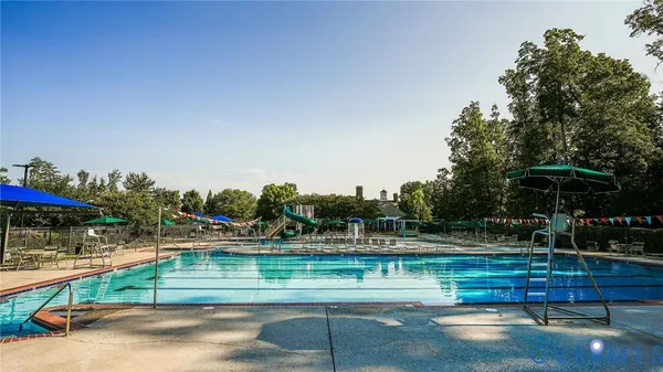 a view of swimming pool with lounge chairs