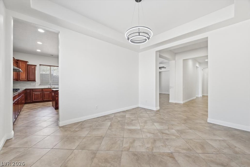 2125 De Rouge Avenue Henderson, NV 89044 - Photo 35 of 96 A well-lit, open-concept living space connects seamlessly to a contemporary kitchen.