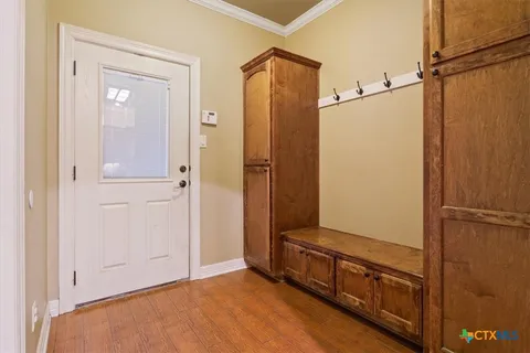 a kitchen with white cabinets and white appliances