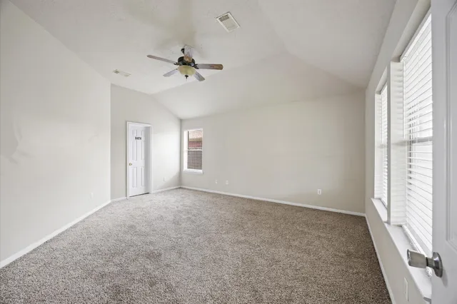 a view of a livingroom with a ceiling fan and window