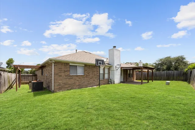 a view of a house with a yard and sitting area