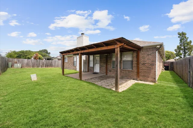 a view of a house with a yard and a garden