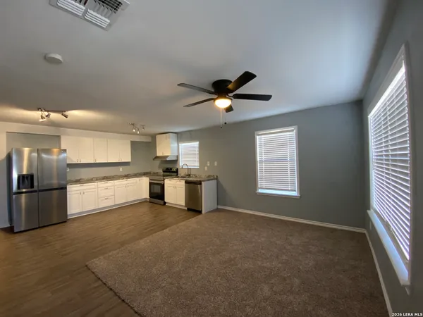 a view of a kitchen with a sink and stainless steel appliances