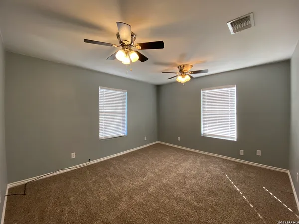a view of a livingroom with a ceiling fan and window