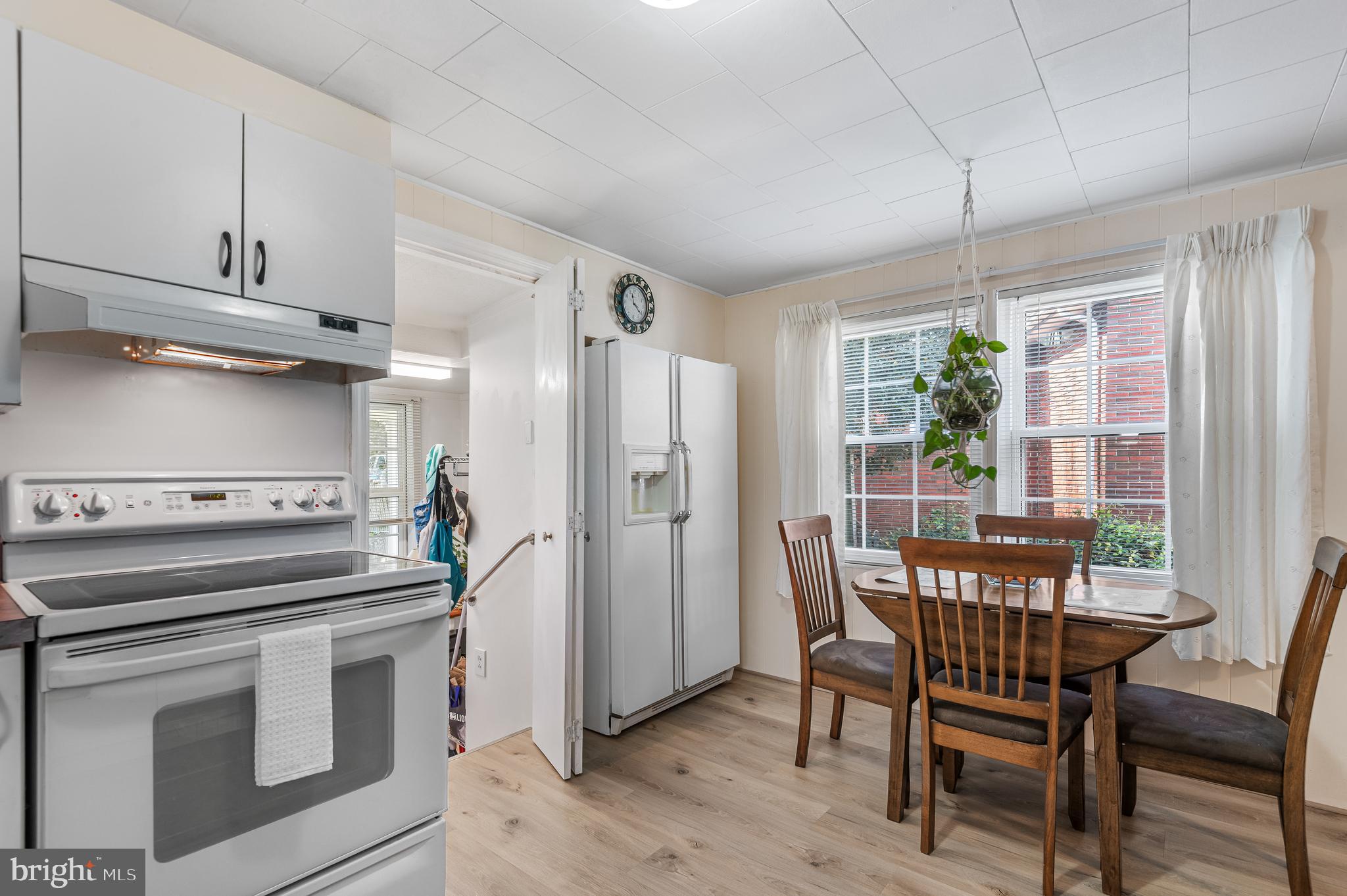 111 Compass Road Baltimore, MD 21220 - Photo 16 of 36 a kitchen with stainless steel appliances a stove a table and chairs