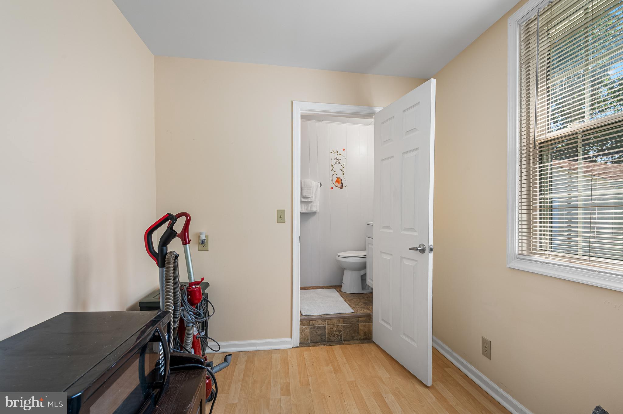 111 Compass Road Baltimore, MD 21220 - Photo 21 of 36 a room that has a toilet and a wooden floor