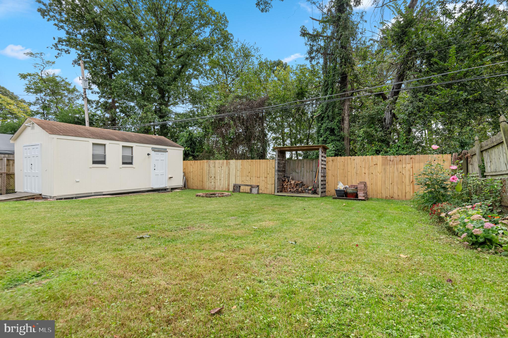 111 Compass Road Baltimore, MD 21220 - Photo 35 of 36 a view of a backyard with a garden and tree