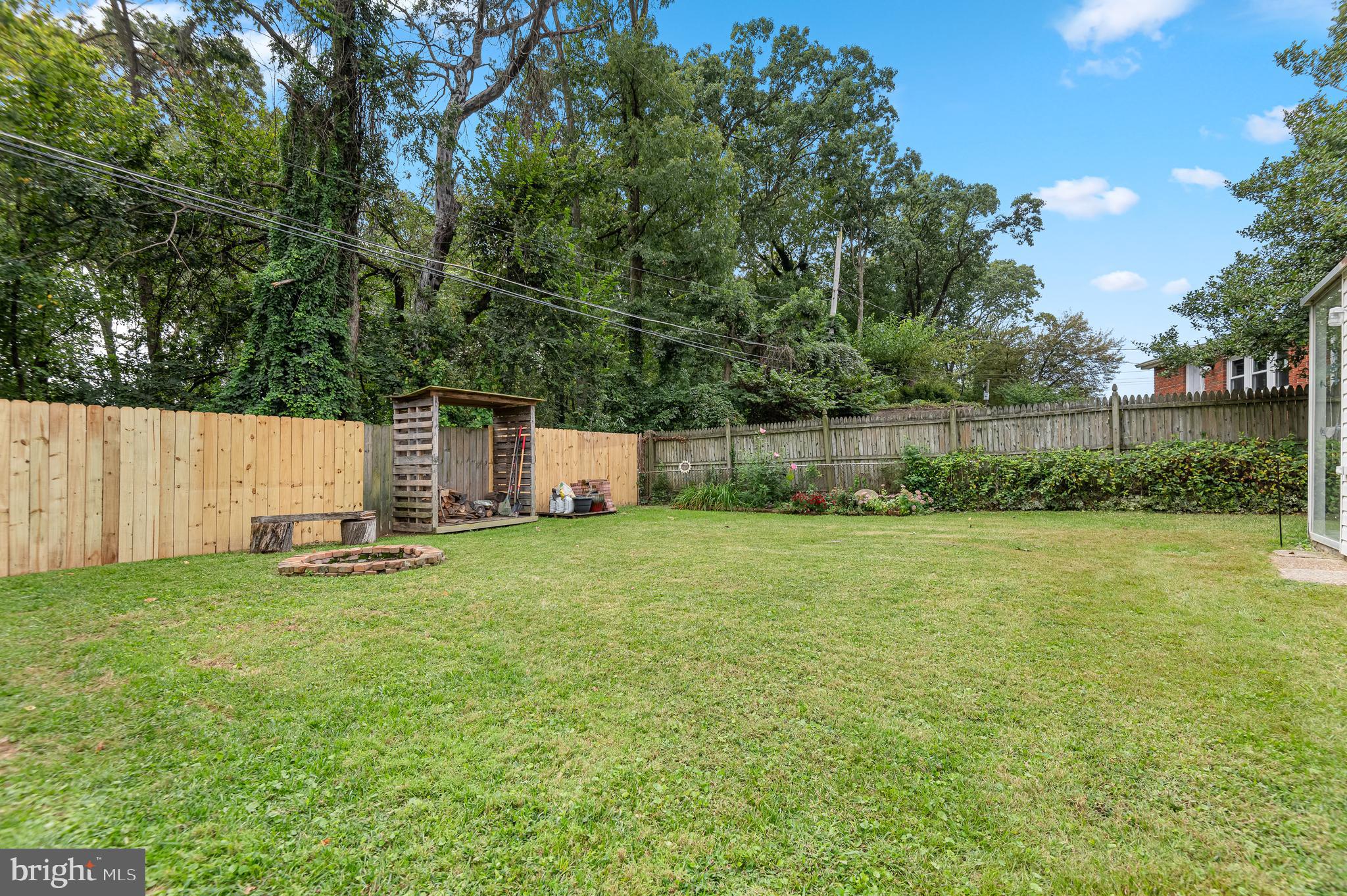 111 Compass Road Baltimore, MD 21220 - Photo 36 of 36 a backyard of a house with a bench and trees